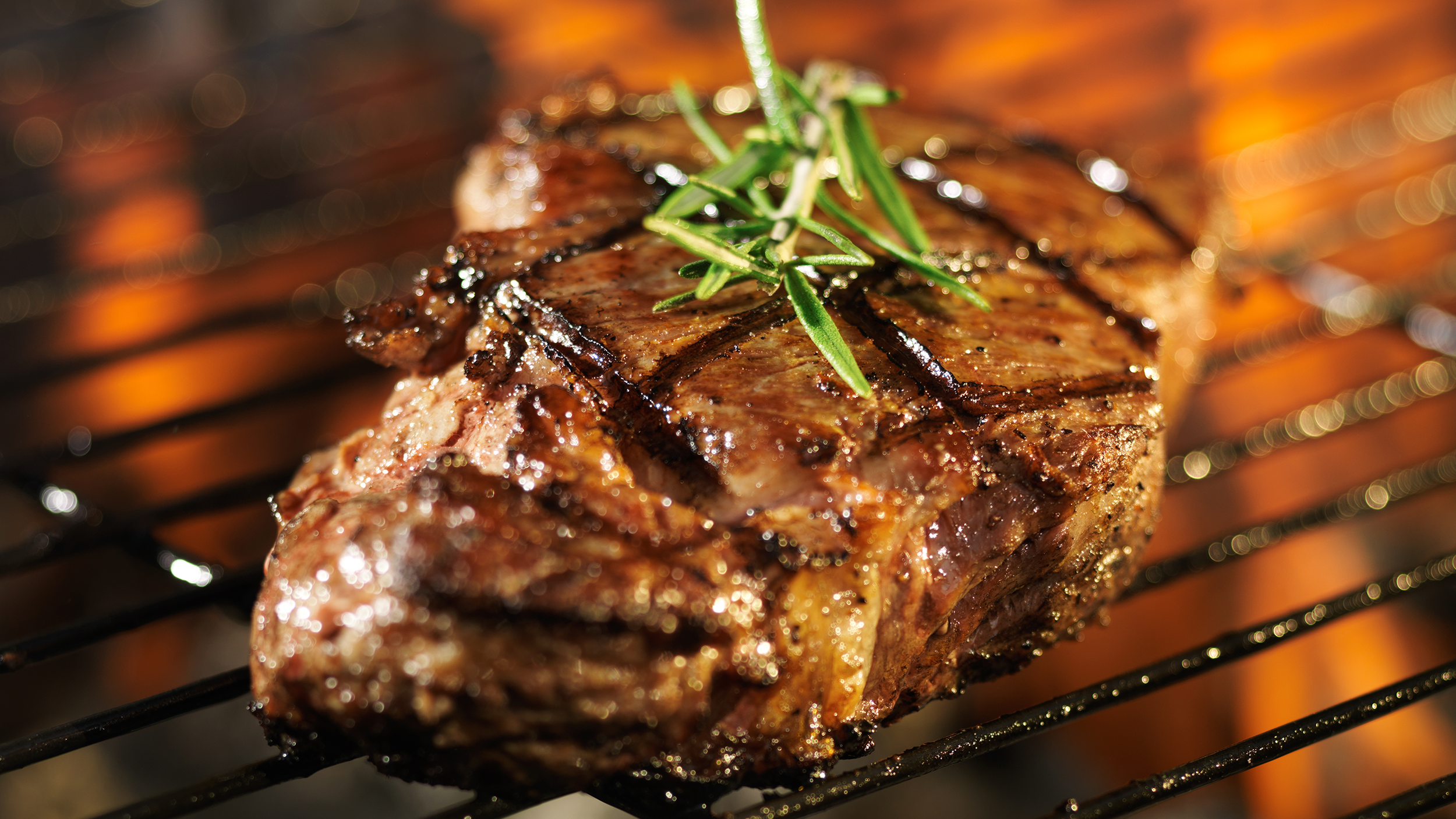 steak-cooking-over-flaming-grill-HTBB